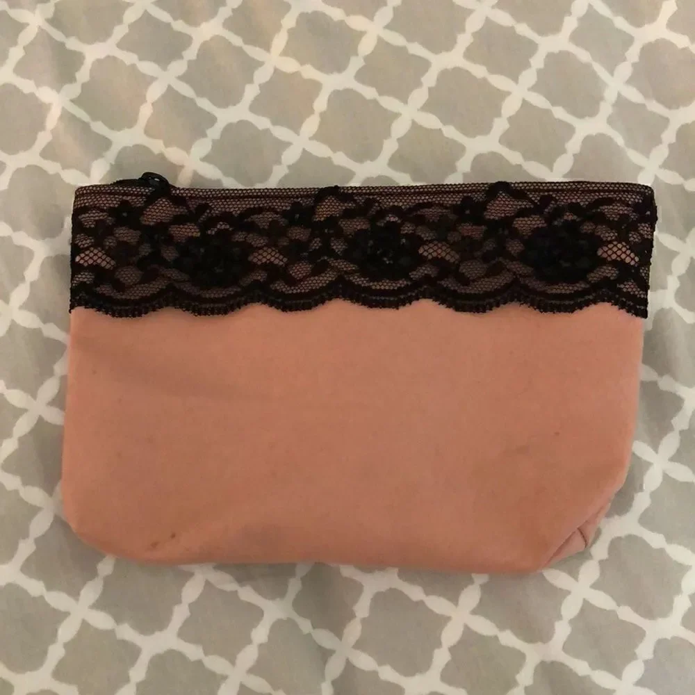 IPSY pink cosmetics bag with black lace trim, includes 5 trial products